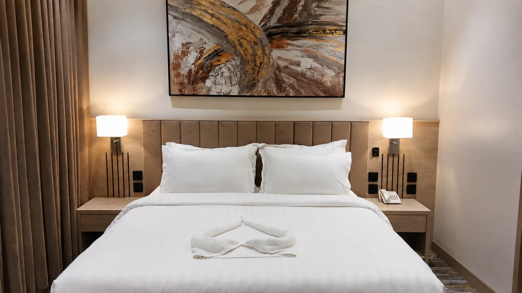A neatly prepared bedroom in warm light